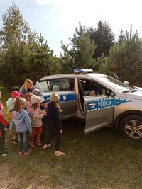 dzieci oglądające policyjny radiowóz w czasie spotkania z policjantem