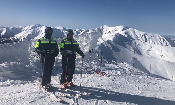 policyjny patrol na nartach w górskiej scenerii