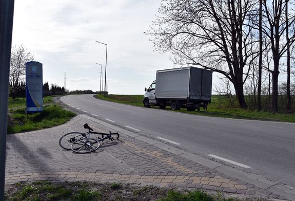 skrzyżowanie, miejsce wypadku, na drodze leży rower, na poboczu stoi pojazd marki Renault