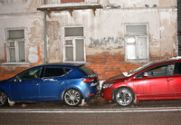 na ulicy stoją dwa samochody osobowe jeden za drugim