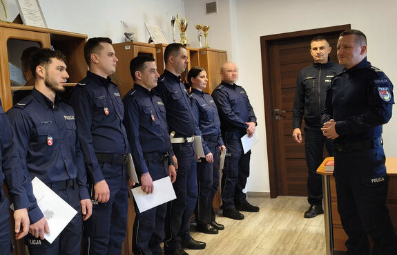 Komendant Miejski Policji w Zamościu, Jego Zastępca nadkomisarz Marcin Muzyka oraz stojący w szeregu  awansowani policjanci.